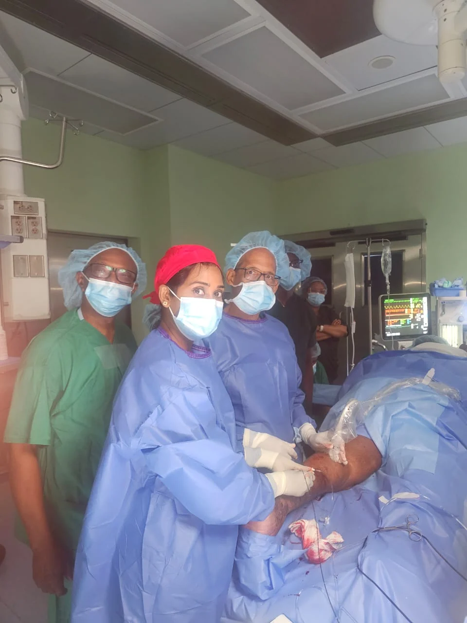 Operating room team gathered around a case